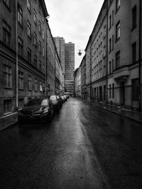 Street amidst buildings against sky in city