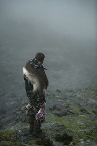 Hunter in mountains carrying meat