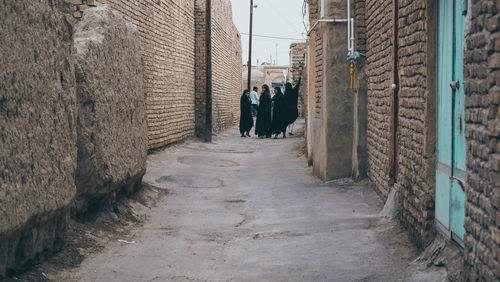 People walking on wall of building