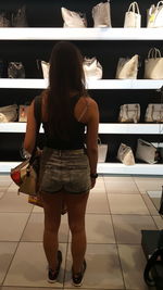 Rear view of woman standing in store