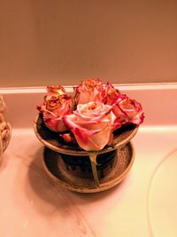 Close-up of red rose on table