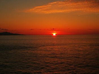 Scenic view of sea against romantic sky at sunset