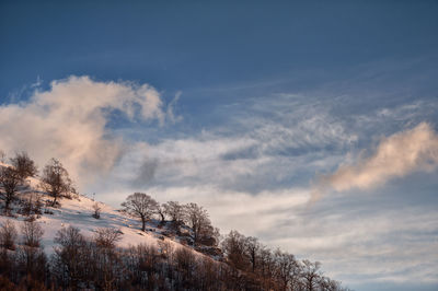 Low angle view of snowcapped mountain against sky