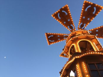 Low angle view of illuminated building against clear sky at night