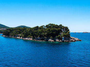 Scenic view of sea against clear blue sky