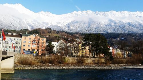 Scenic view of river by mountains against sky