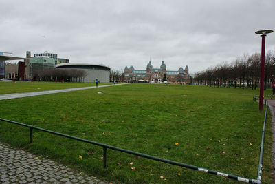 Buildings in city against cloudy sky