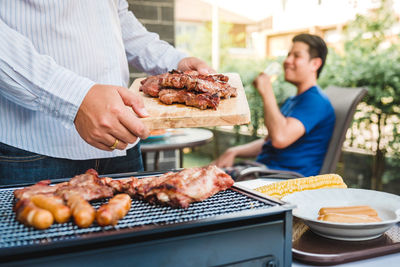 Man preparing food on barbecue grill