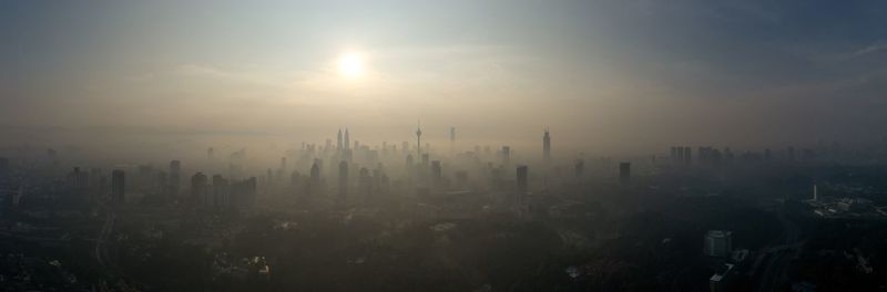 Panoramic view of city against sky during sunset