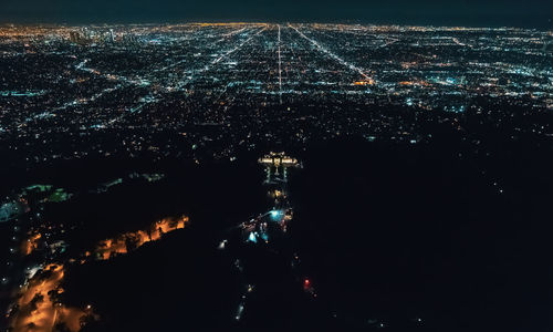 High angle view of illuminated buildings in city at night