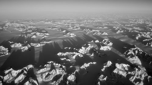 Aerial view over snow capped mounbtains, greenland