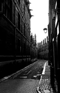 Surface level of street amidst buildings against sky