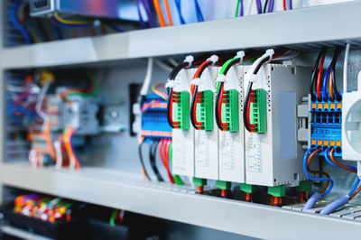 Several batch switches in an electrical control cabinet on a production line surrounded by inverters