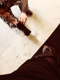 Low section of woman standing on tiled floor