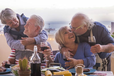 Happy senior couples at dining table