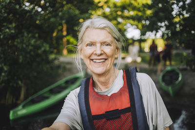 Portrait of happy senior woman wearing life jacket