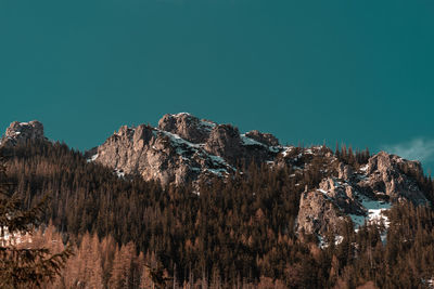 Panoramic view of trees and mountains against clear blue sky