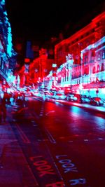 Defocused image of illuminated street at night