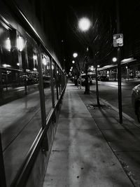 Illuminated railroad station platform at night