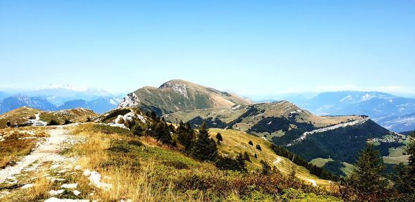 Scenic view of mountains against clear blue sky