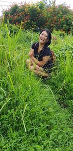 Portrait of smiling young woman on field