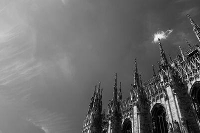 Low angle view of building against cloudy sky