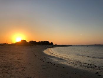 Scenic view of sea against clear sky during sunset