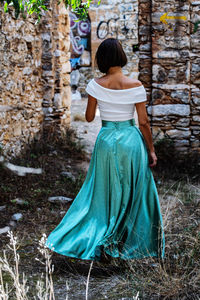 Rear view of woman standing against plants