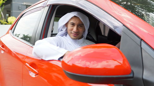 Portrait of young woman in car