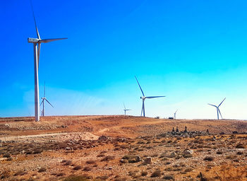 Windmill on field against sky