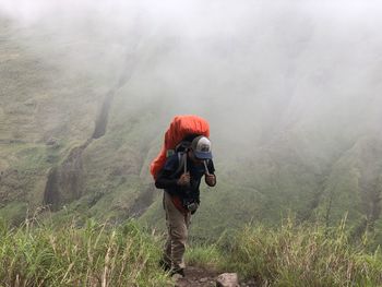 Rear view of man standing on mountain