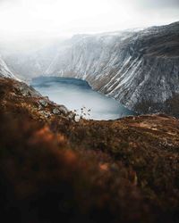 Scenic view of lake amidst mountains against sky