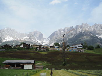 Scenic view of mountains and houses against sky