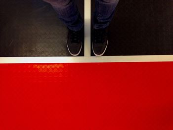 Low section of person standing on road