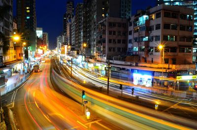 Light trails on road along buildings at night