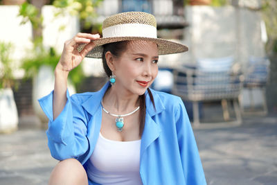 Portrait of young woman in hat