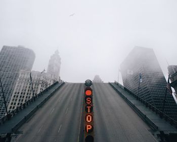 Low angle view of michigan avenue bridge by buildings against sky