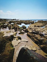 Rocks in sea against sky