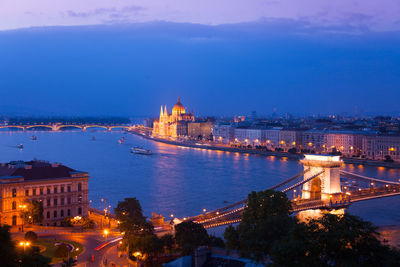 High angle view of city lit up at night