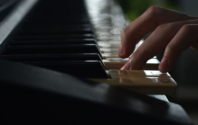 Midsection of man playing piano