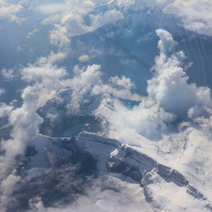 Aerial view of snowcapped mountains against sky