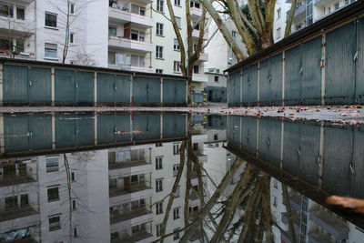 Reflection of buildings in puddle on lake