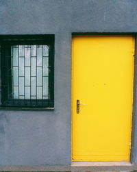 Yellow closed door of building