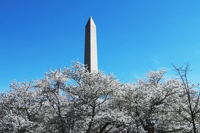 Low angle view of tower against clear blue sky