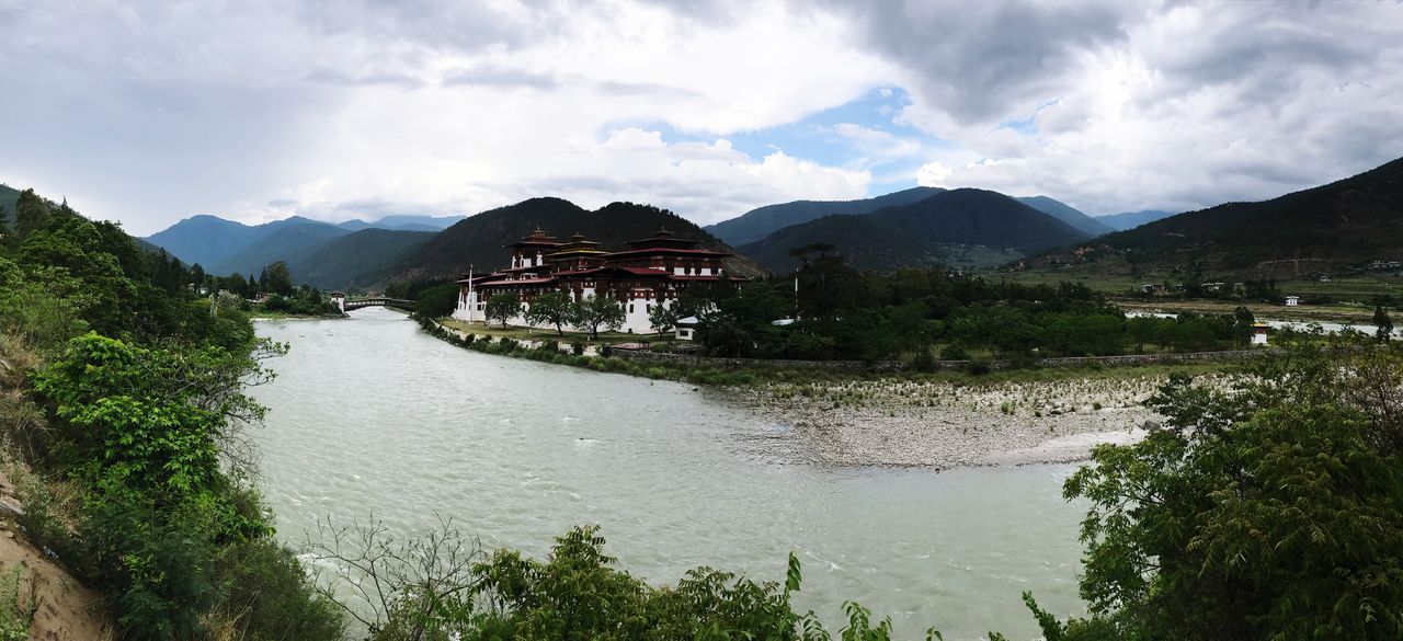 architecture, built structure, sky, mountain, building exterior, water, scenics, day, cloud - sky, no people, outdoors, river, waterfront, mountain range, nature, beauty in nature, travel destinations, tree