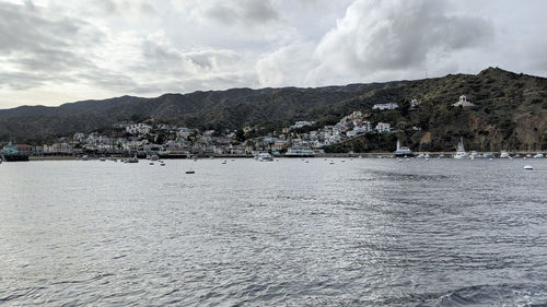 Panoramic shot of townscape by sea against sky