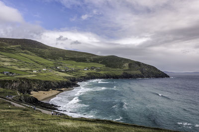 Scenic view of sea and mountains against sky