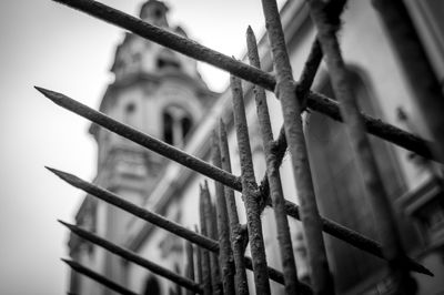 Low angle view of spiked fence against church