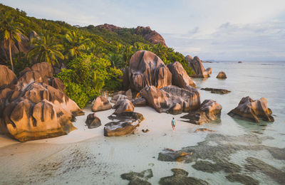 Rocks on beach against sky