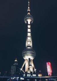 Low angle view of illuminated tower at night